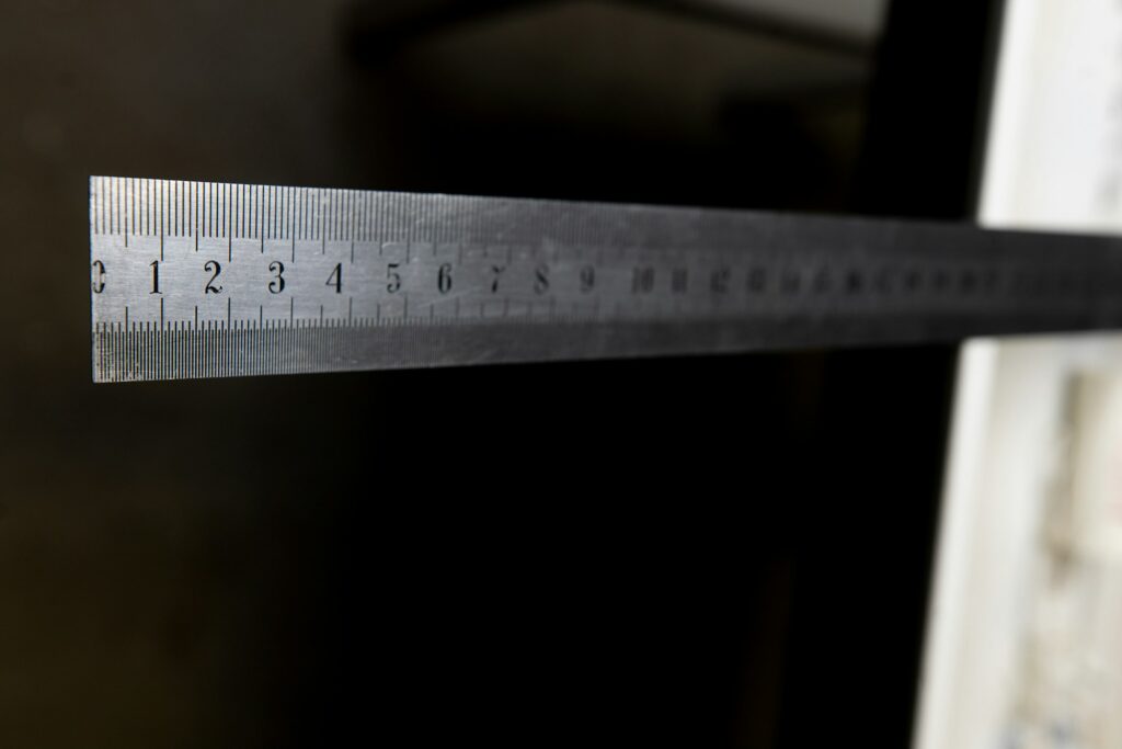iron ruler with numbers on black background