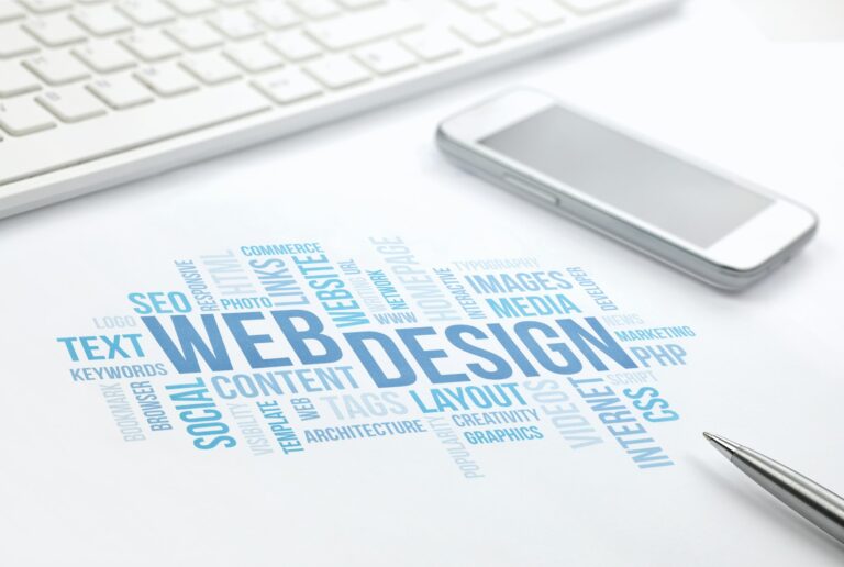 Web Design business concept word cloud print document, keyboard, pen and smartphone