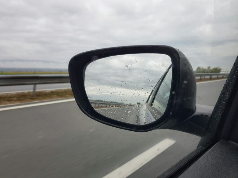 Close-up image of car rear view mirror from inside of the car.
