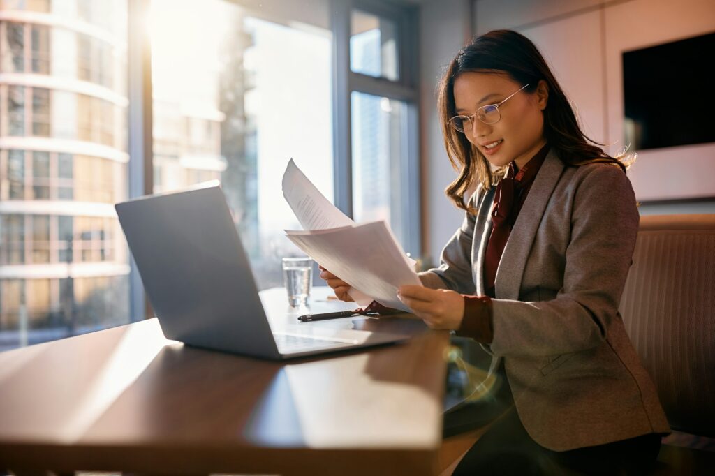 Asian businesswoman analyzing reports while working in the office.