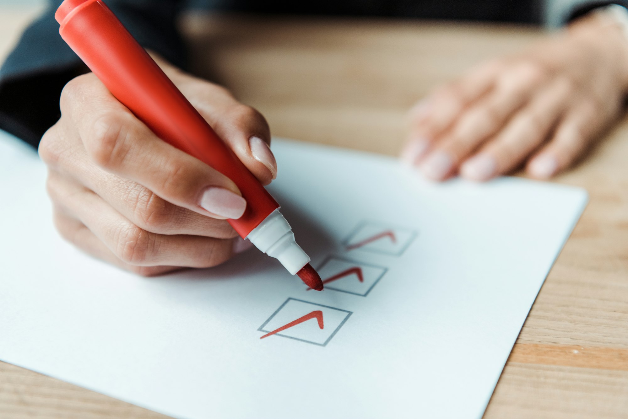 cropped view of woman putting check park in check list