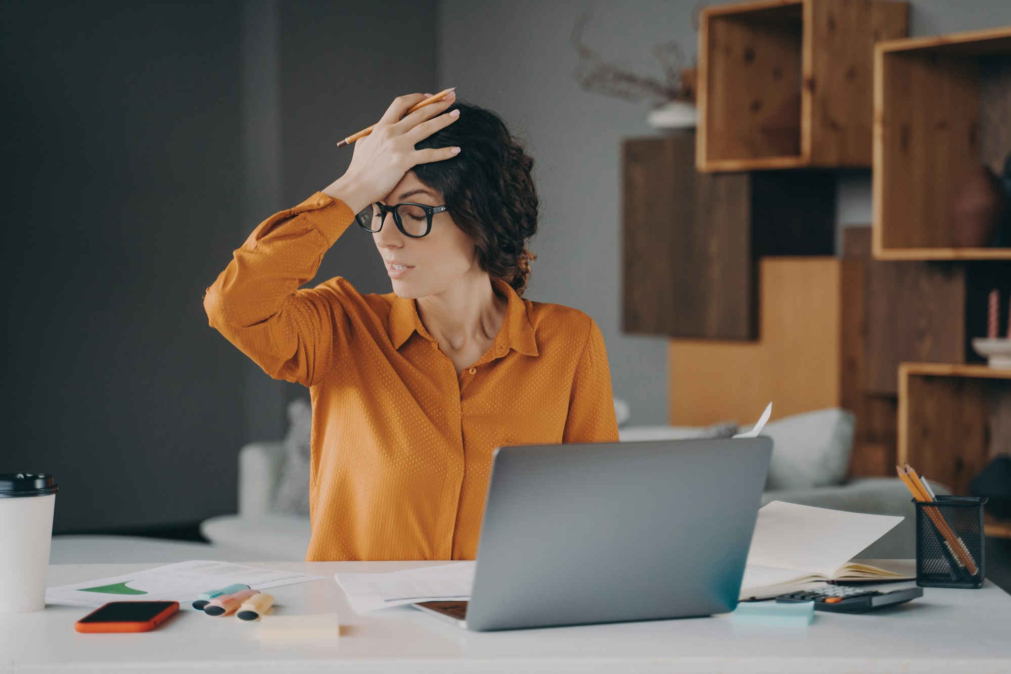 Frustrated Italian female employee stressed about mistake or problem with computer