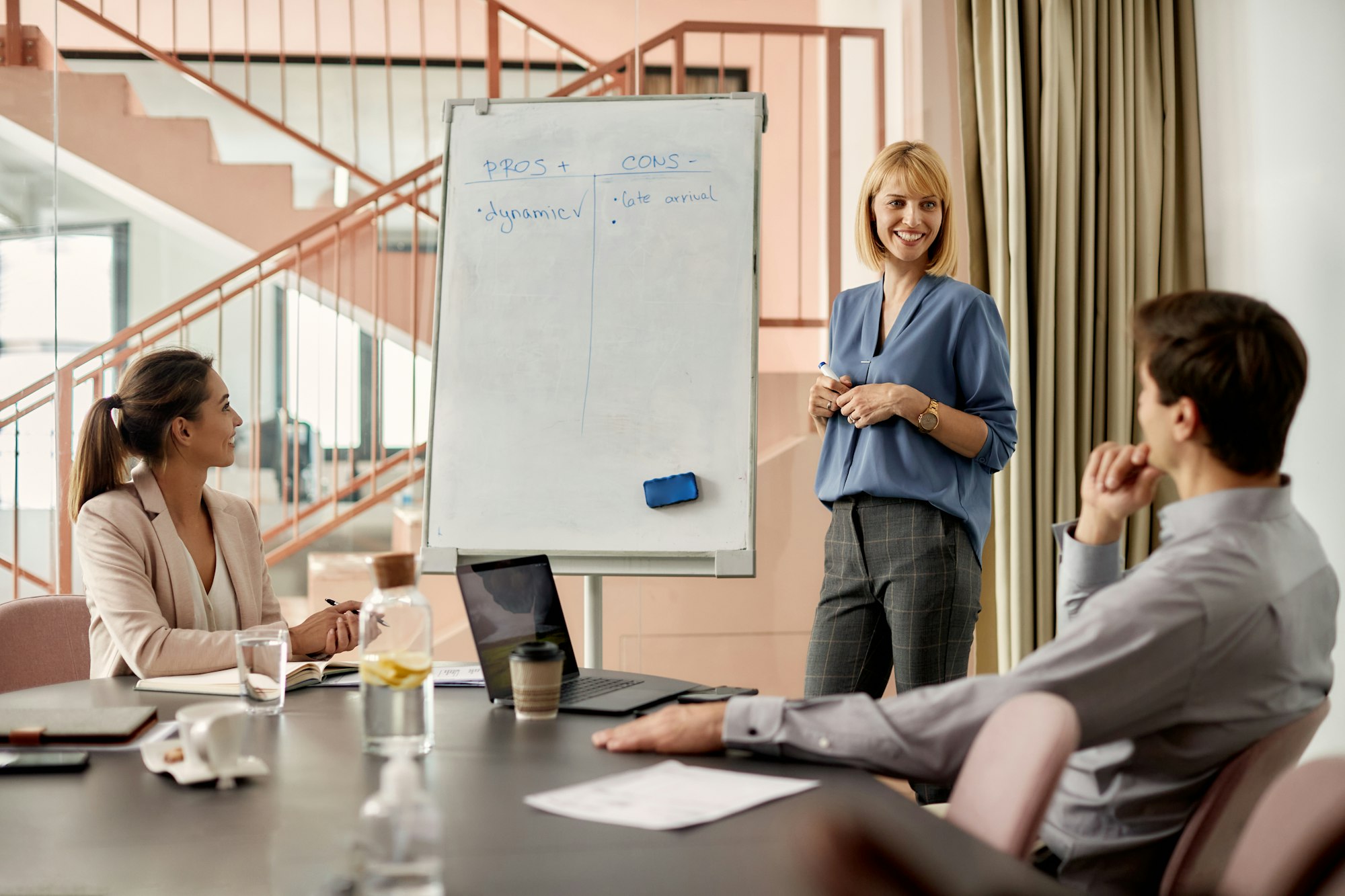 Happy businesswoman talking to her colleagues during a presentation in the office