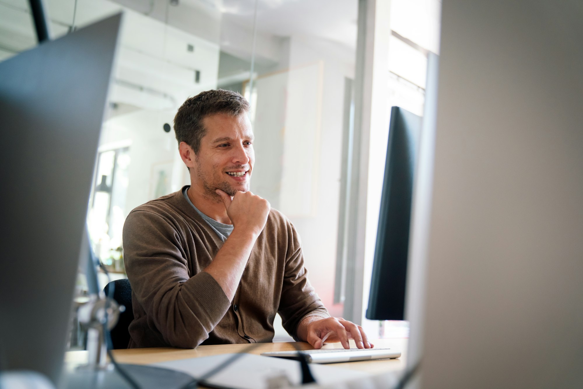 Programmer, web developer, designer working at office comparing mobile and desktop website versions