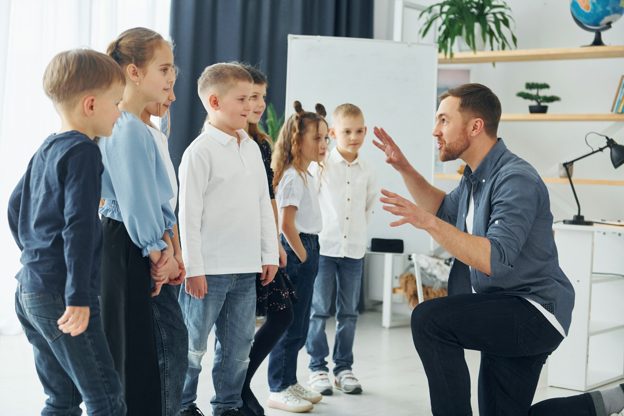 Storyteller with interesting information. Group of children students in class at school with teacher