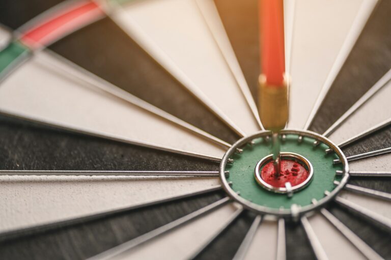 The red arrow in the middle of the dart board shown success. The concept of setting business goals