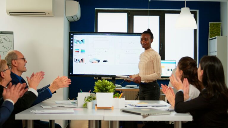 Black analyst using digital interactive whiteboard for presentation
