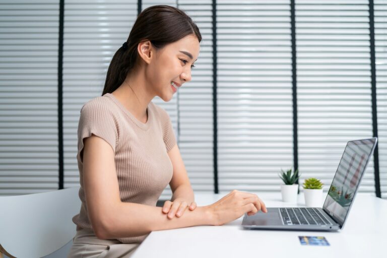 Asian young woman use laptop computer for shopping product sell online.