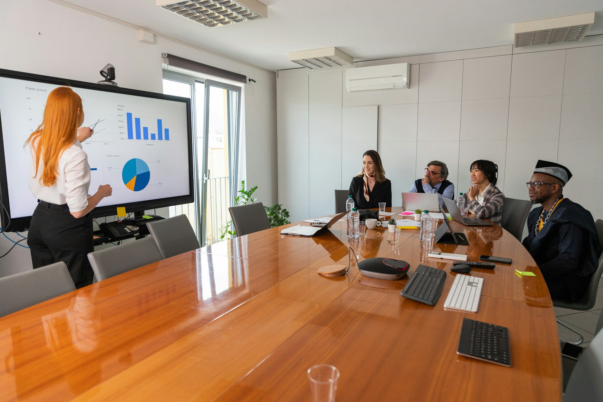 A businesswoman presents slides to her colleagues during a conference