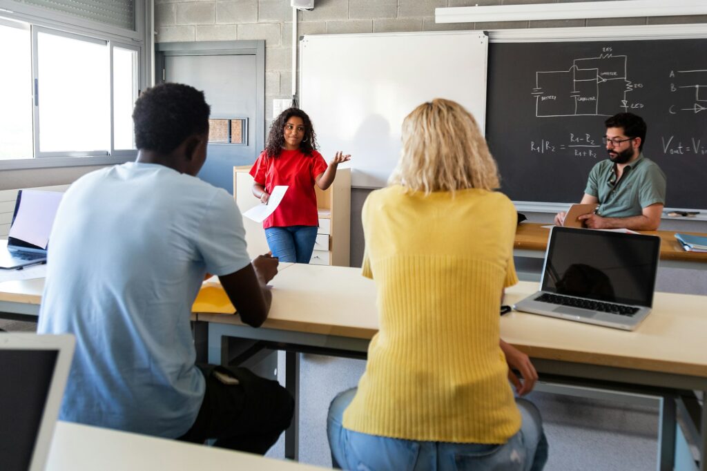 African American female high school student giving oral class presentation.