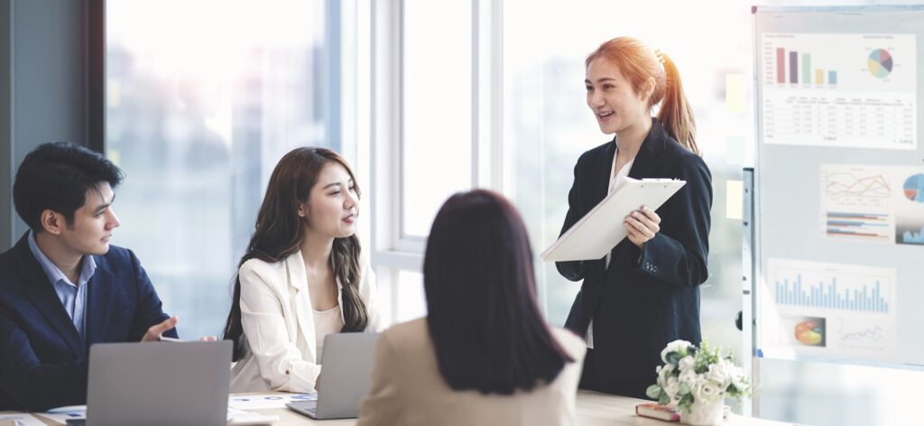 Asian Businesswoman making a presentation to her colleagues in office.