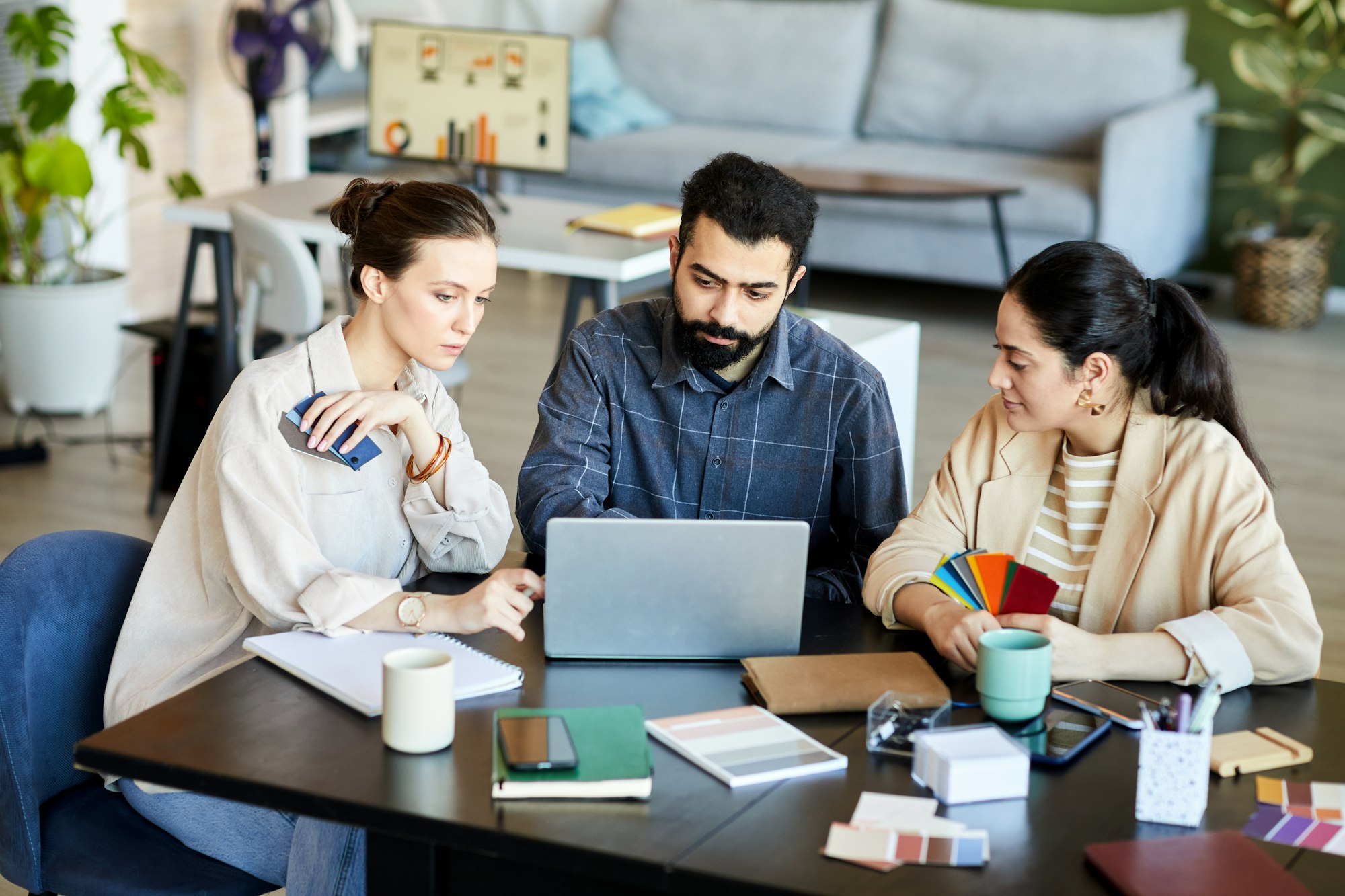 Group of young confident coworkers watching online video presentation