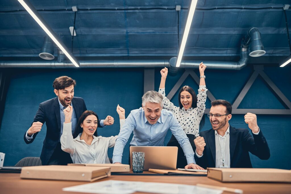 Happy business people clapping after presentation of their colleague