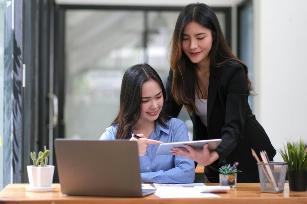 Two Young Asian businesswoman discuss with new startup project Idea presentation