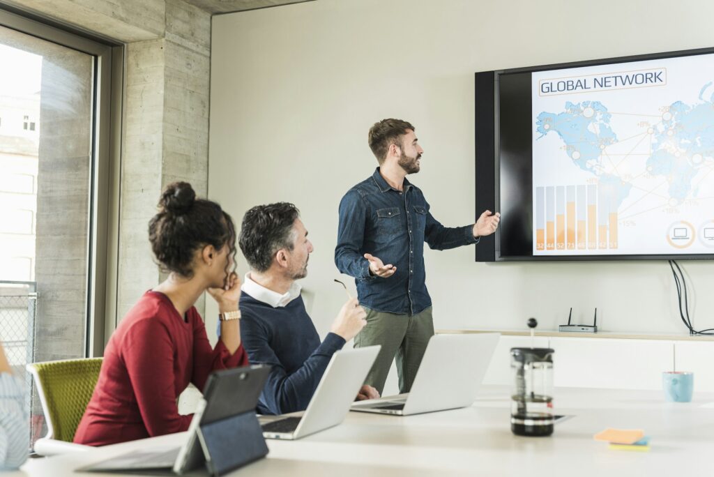 Young businessman leading a presentation in boardroom