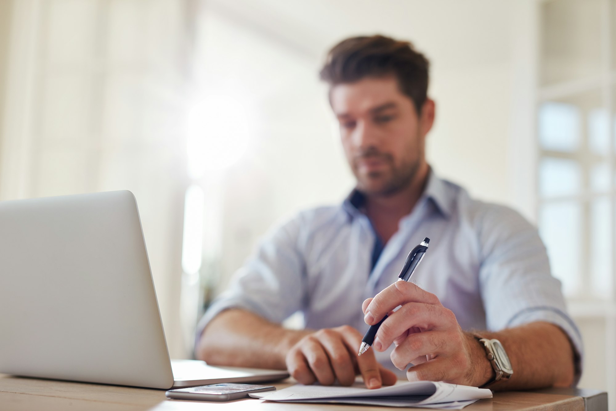 Businessman at home office taking notes