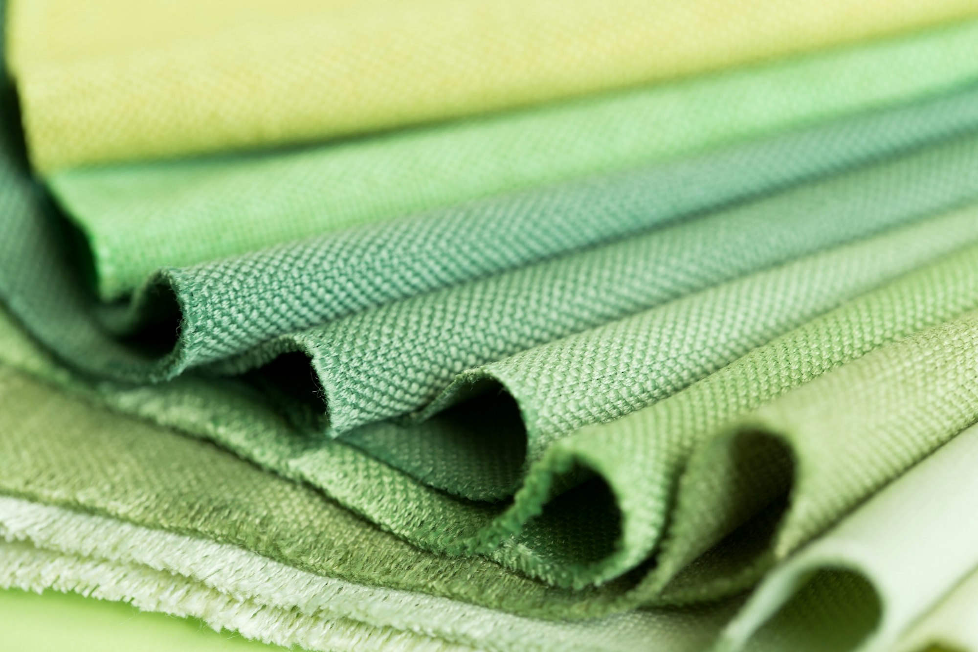 Close up shot of various shades of green color fabrics