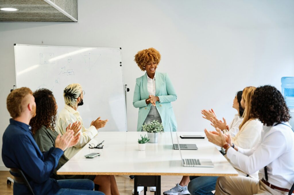 Colleagues applauding the presentation of a project of a coworker