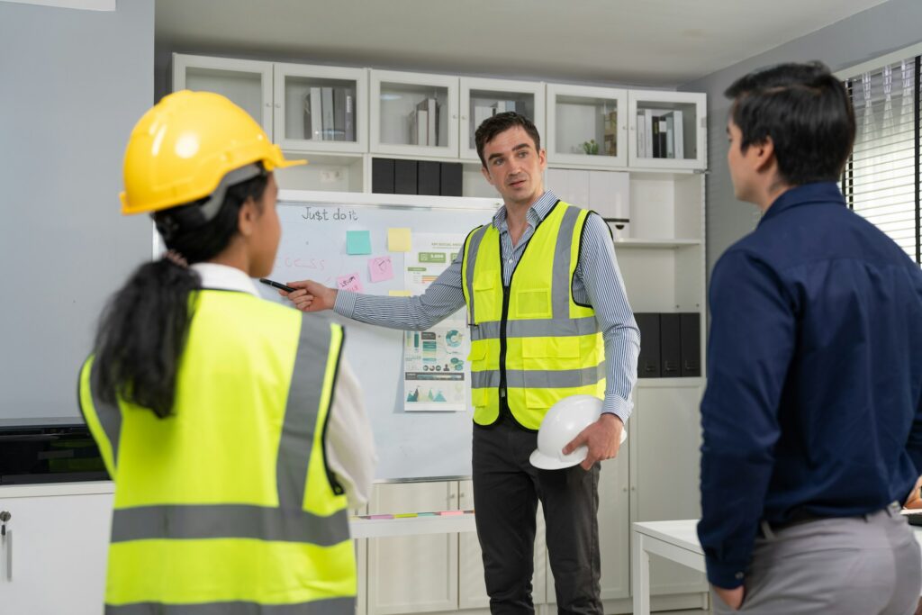 Engineer man presentation project and strategy plan on whiteboard at construction site office