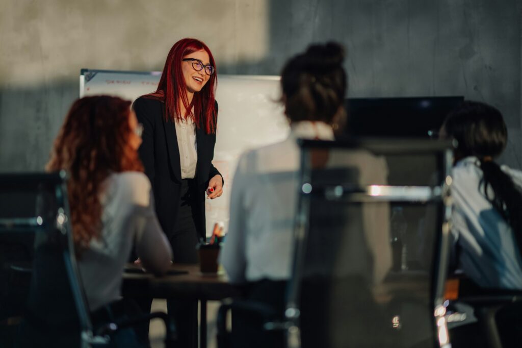 Friendly businesswoman having presentation with business partners.