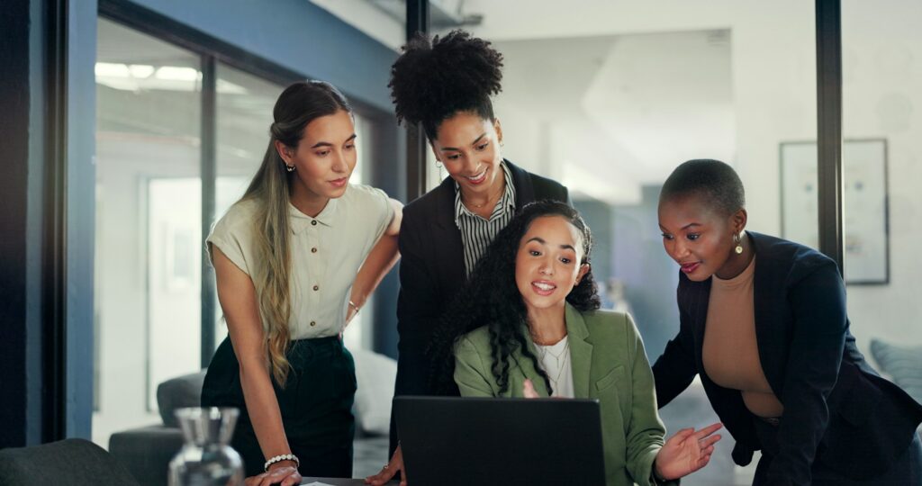 Laptop, diversity group and talking women review financial portfolio, stock market feedback or bitc