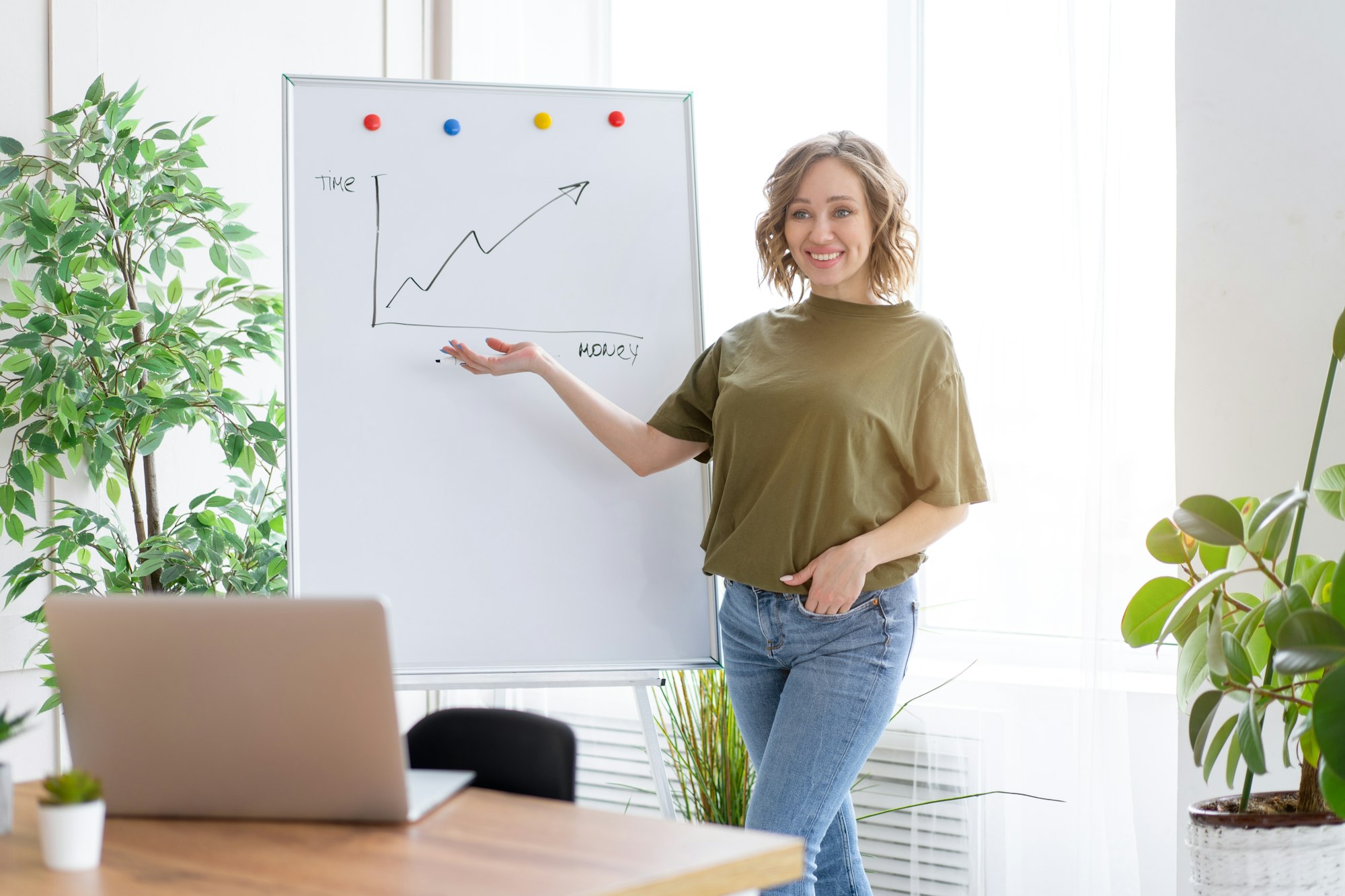 Online presentation with laptop Woman showing growth graph drawn on white board