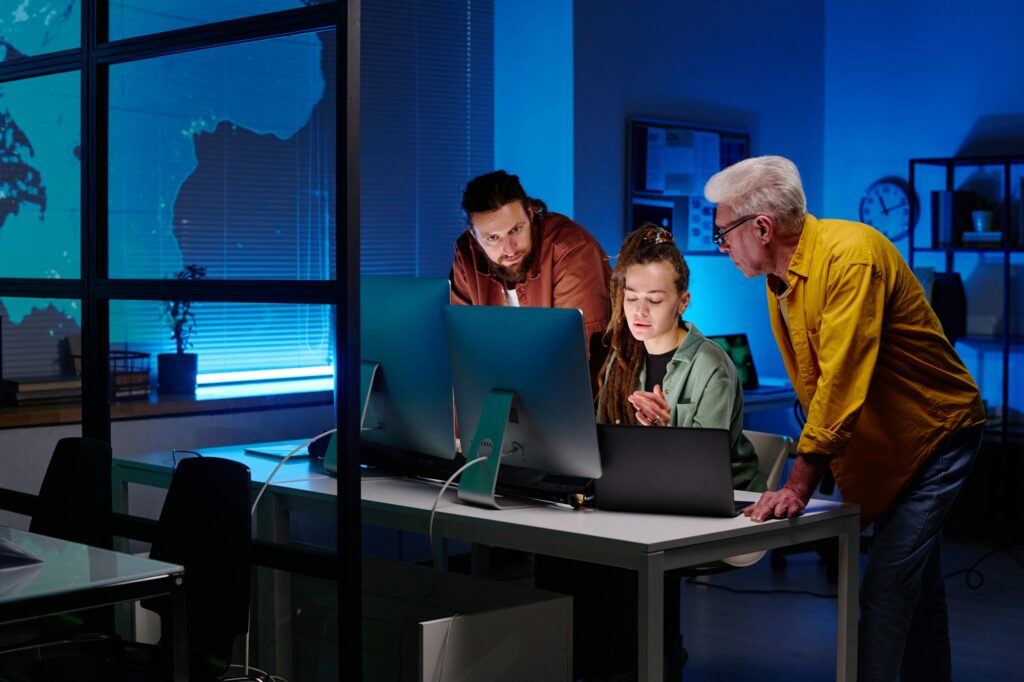 Three colleagues working over new project or software in front of computers