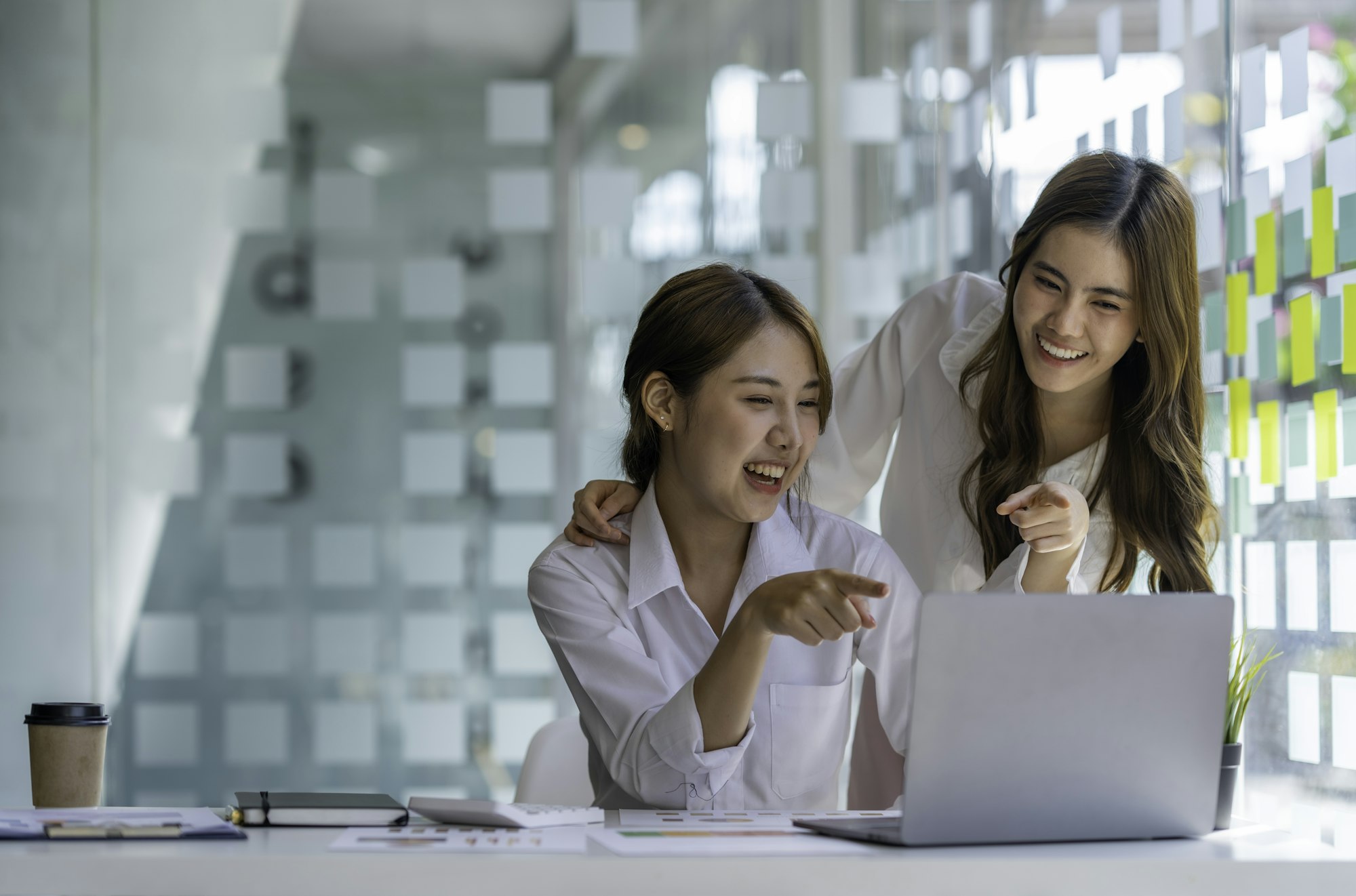 Two Young Asian businesswomen discuss with new startup project Idea presentation, analyze planning a