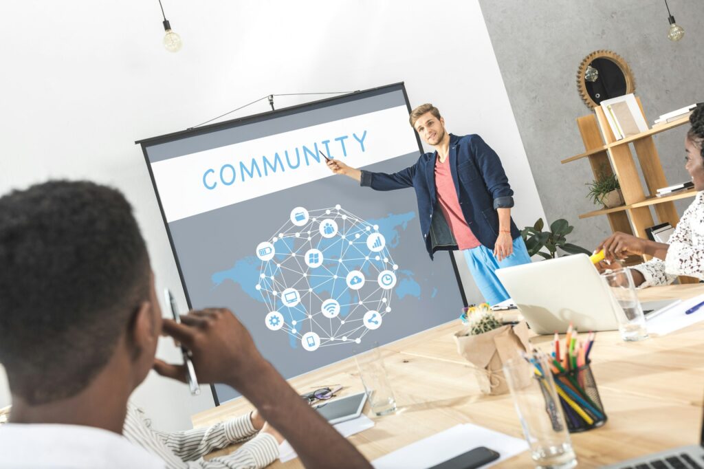 young businessman making presentation for colleagues at meeting in office