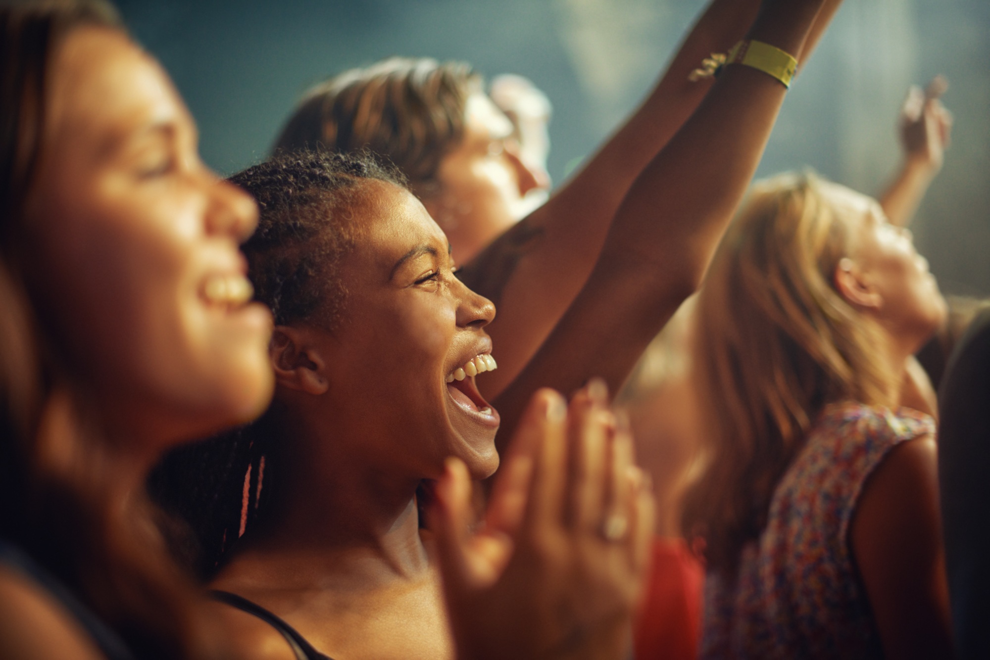 Young girls in an audience enjoying their favourite bands performance