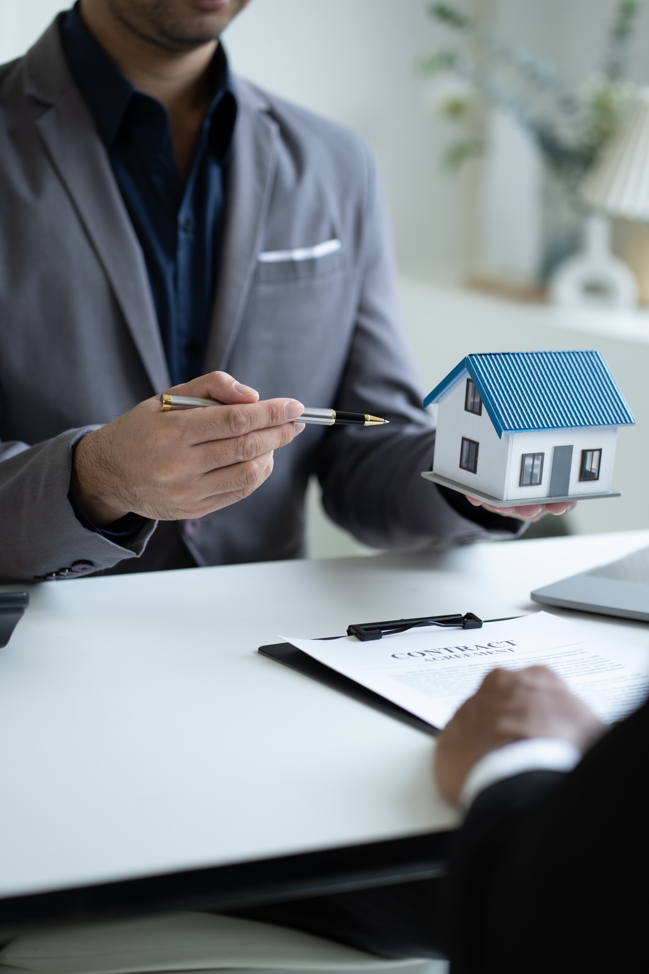 Close up Real Estate agent explain signing agreement for buying house. Bank manager and real estate